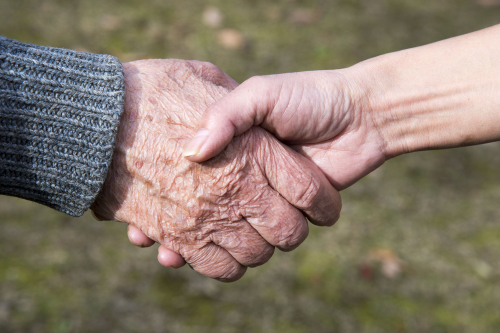 Close-up,Of,Elderly,Caregiver,And,Daughter's,Hands
